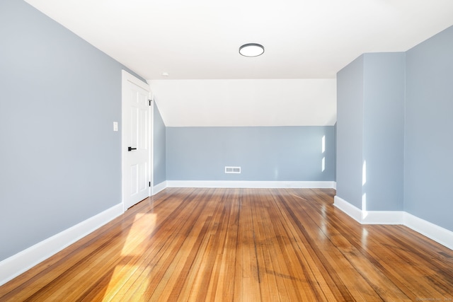 bonus room featuring lofted ceiling and hardwood / wood-style floors