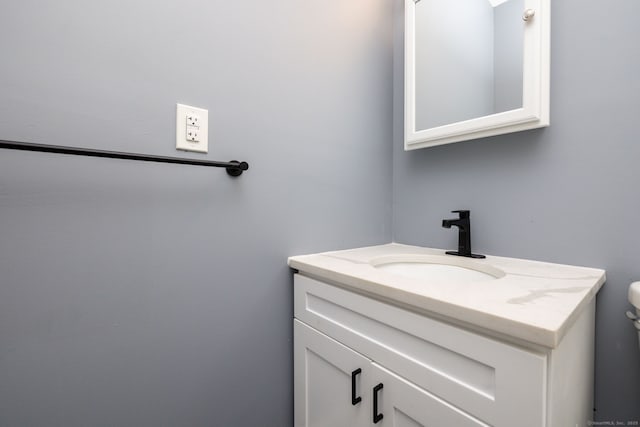 bathroom featuring toilet and vanity