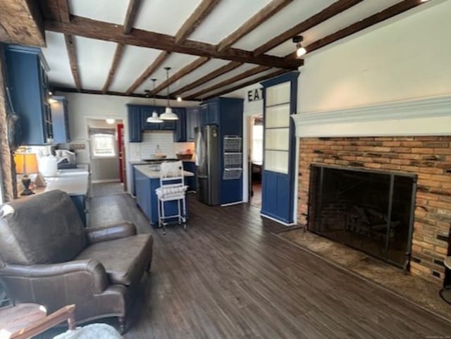 332 Belden Hill Rd, Wilton, CT 06897 - living room with beamed ceiling, a healthy amount of sunlight, a fireplace, and dark wood-type flooring