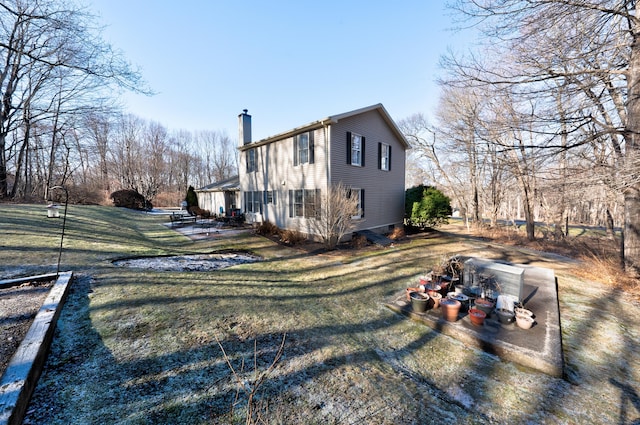 view of side of home featuring a lawn