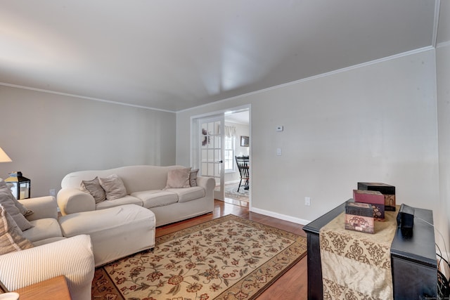 living room with hardwood / wood-style flooring and crown molding