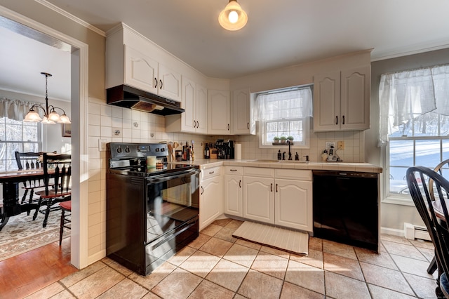 kitchen with sink, black appliances, white cabinets, light tile patterned flooring, and decorative light fixtures