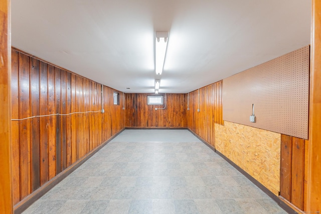 basement featuring wooden walls