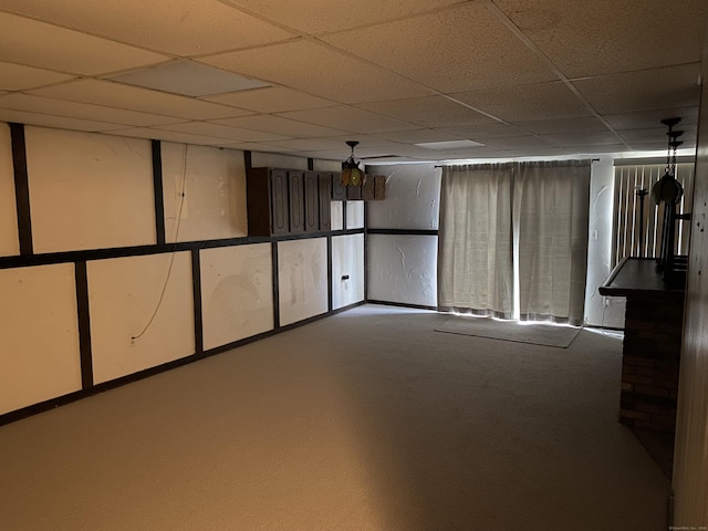 basement with carpet and a drop ceiling