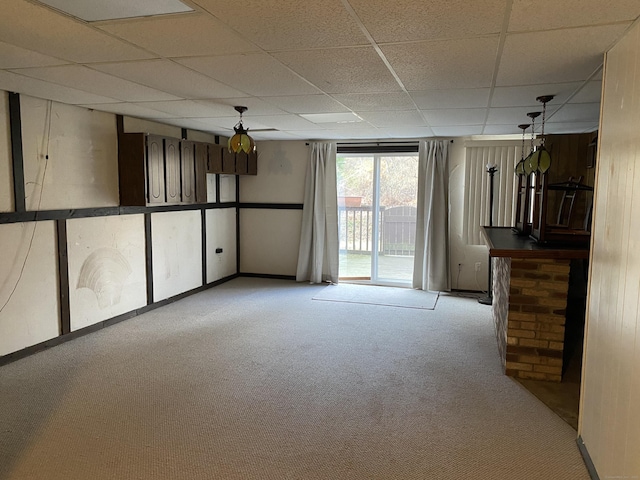 carpeted empty room featuring a paneled ceiling