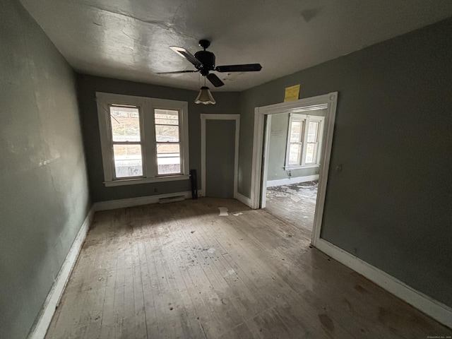 spare room with hardwood / wood-style flooring and ceiling fan