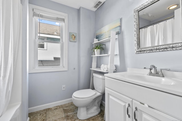 bathroom featuring curtained shower, vanity, and toilet