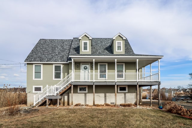 view of front of home featuring covered porch and a front yard