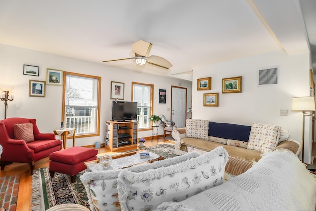 living room featuring ceiling fan and hardwood / wood-style flooring