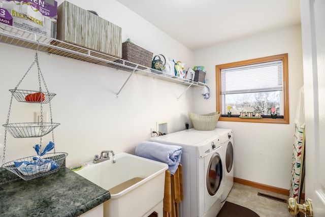 laundry room featuring sink and separate washer and dryer