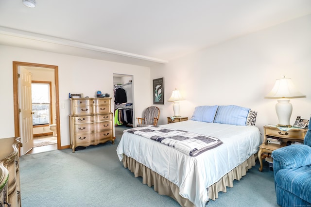 carpeted bedroom featuring a closet, a spacious closet, and connected bathroom