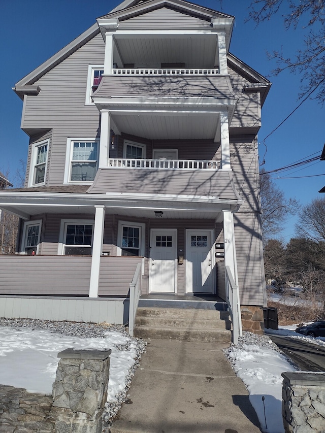 view of front facade with a porch and a balcony