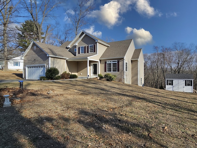 view of front of house featuring a front lawn, a storage unit, and a garage