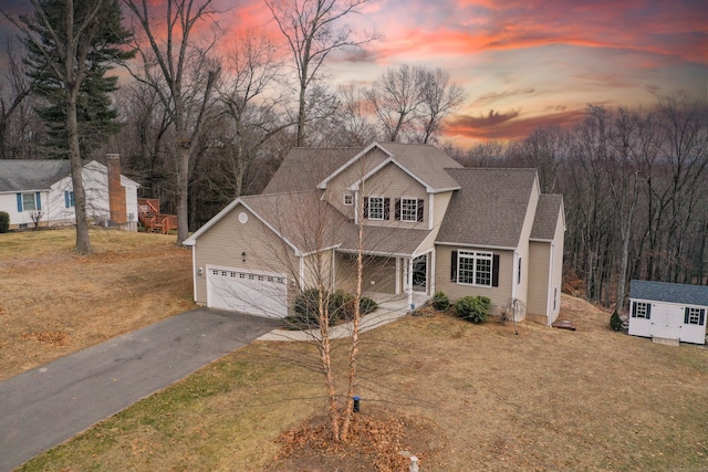 view of front facade featuring a lawn and a garage