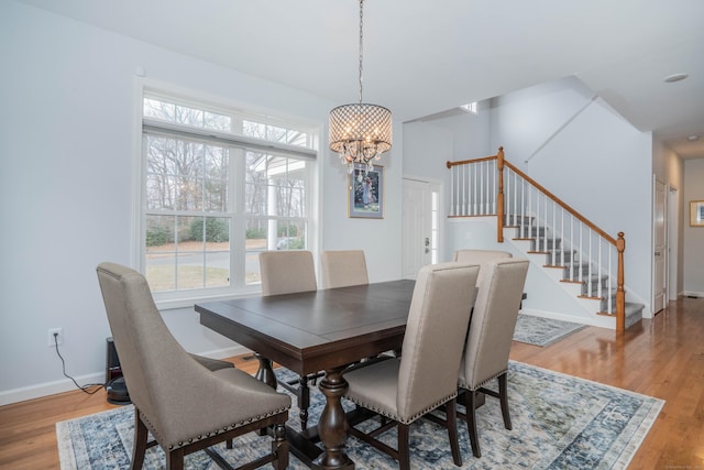 dining area featuring light hardwood / wood-style flooring and a chandelier