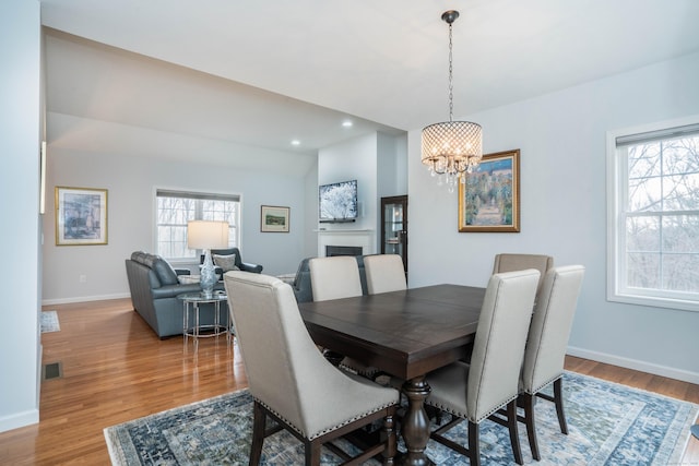 dining room featuring wood-type flooring and a chandelier