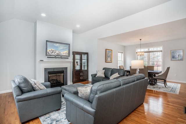 living room with a chandelier and light hardwood / wood-style flooring