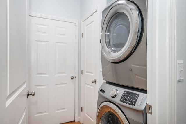 laundry area with stacked washer and dryer