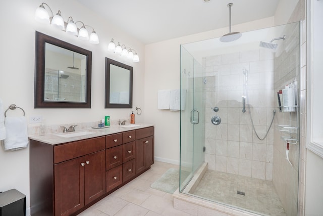 bathroom with tile patterned floors, an enclosed shower, and vanity