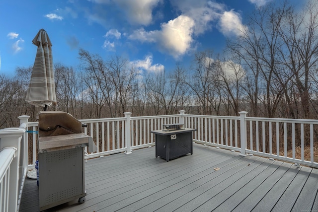 wooden deck featuring a fire pit