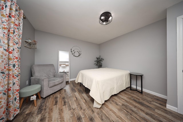 bedroom with dark wood-type flooring