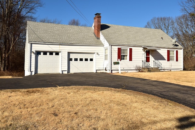 cape cod home with a front yard and a garage