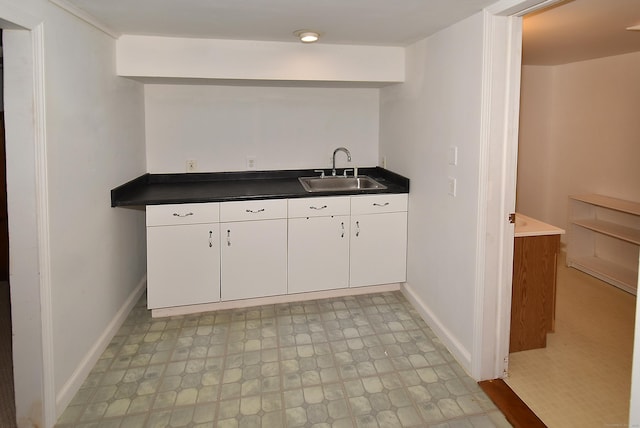 kitchen featuring sink and white cabinets