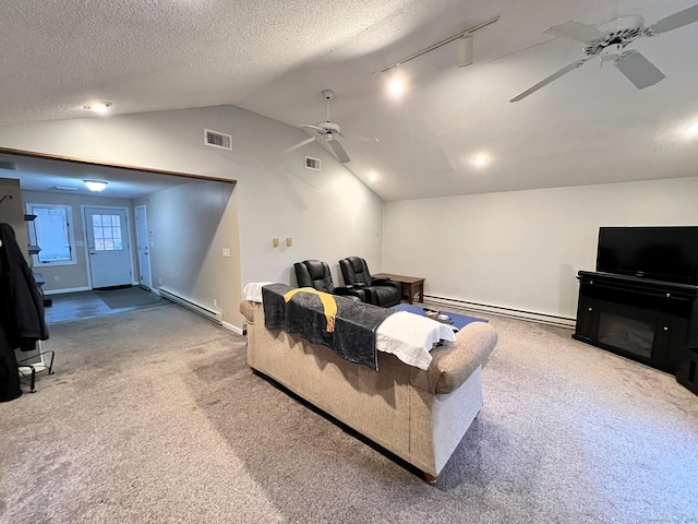 carpeted cinema featuring lofted ceiling, baseboard heating, a textured ceiling, and ceiling fan