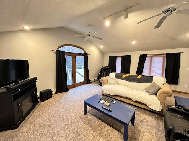 living room featuring light colored carpet, track lighting, and a textured ceiling