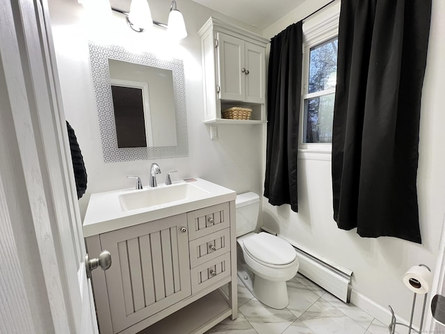 bathroom with toilet, vanity, and a baseboard heating unit