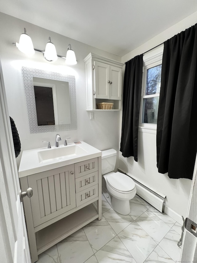 bathroom featuring toilet, vanity, and a baseboard radiator