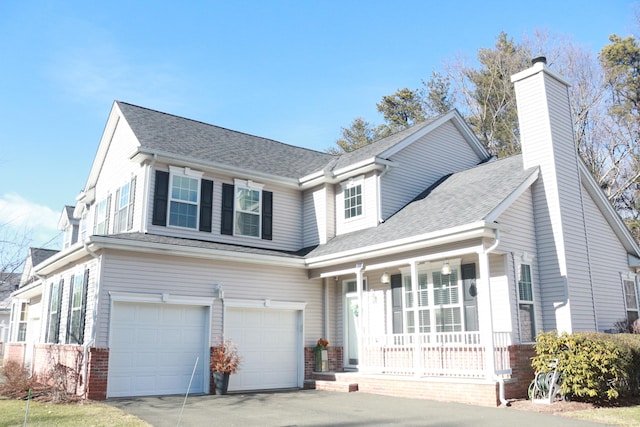 view of front of house featuring a garage and a porch