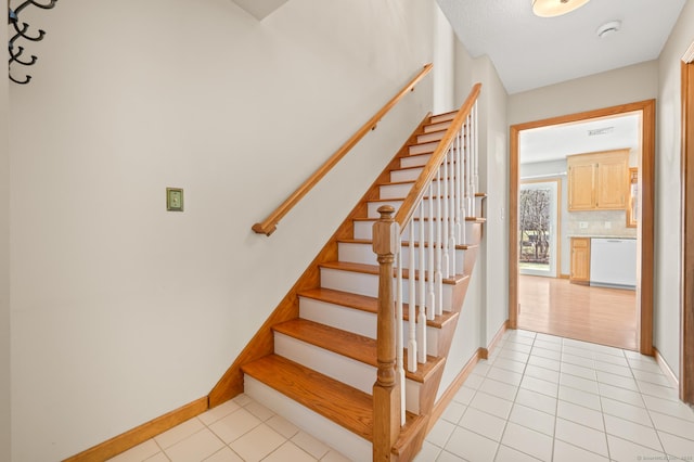 stairway featuring tile patterned flooring