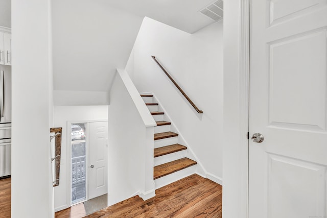 stairway featuring hardwood / wood-style floors