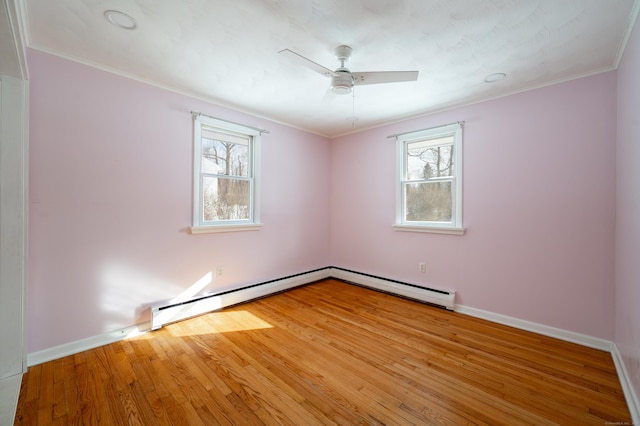 spare room with wood-type flooring, a healthy amount of sunlight, ceiling fan, and crown molding