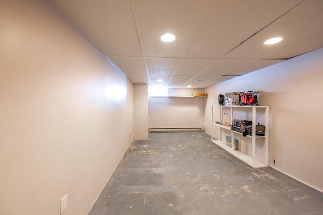 basement with baseboard heating and a drop ceiling