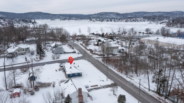 snowy aerial view with a mountain view