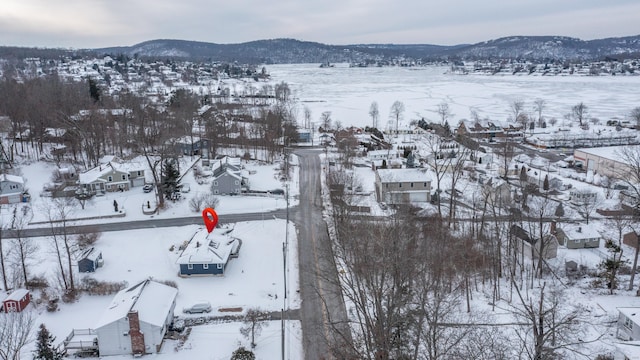 snowy aerial view with a mountain view