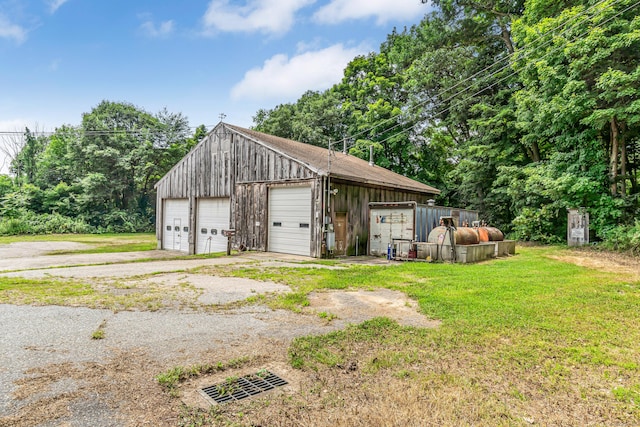 garage featuring a lawn