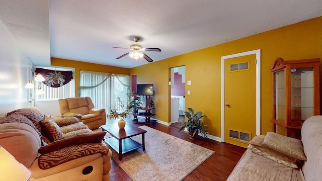 living room featuring a textured ceiling, ceiling fan, and dark hardwood / wood-style flooring