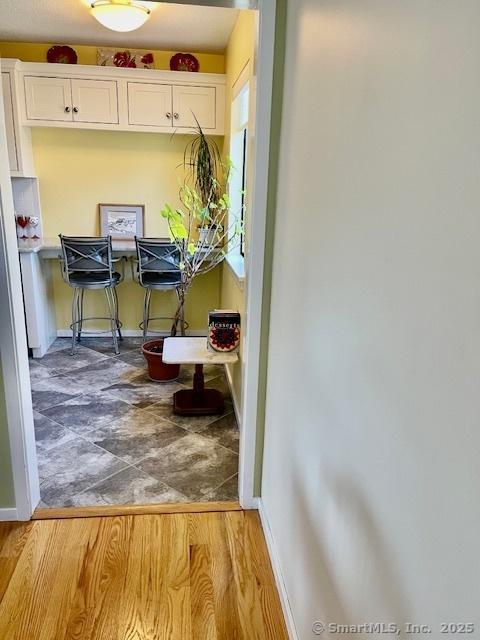 interior space featuring baseboards and wood finished floors