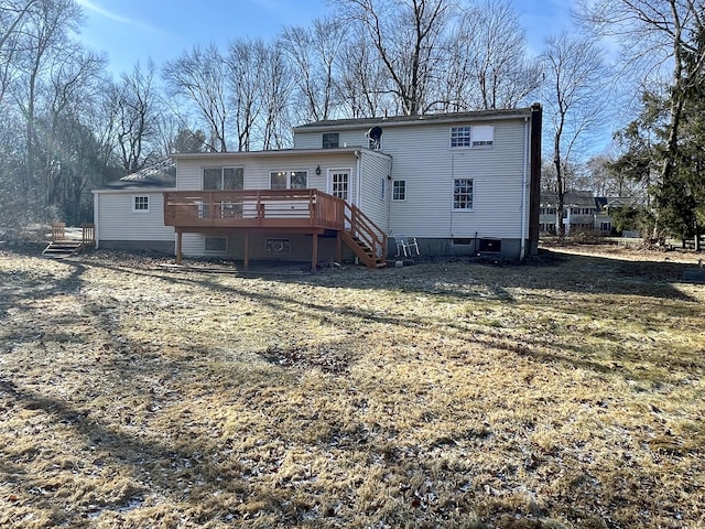 back of house with central air condition unit, a yard, and a wooden deck