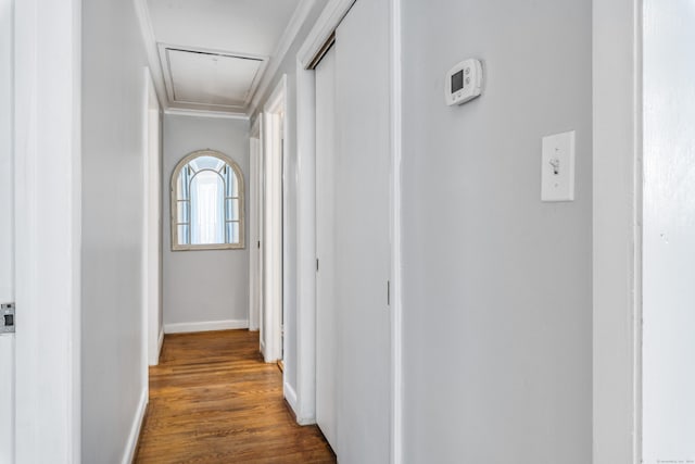 hall with dark hardwood / wood-style flooring and ornamental molding