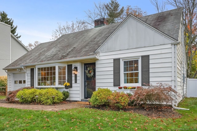 view of front of property with a garage and a front lawn