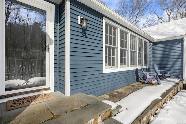 view of snow covered property entrance