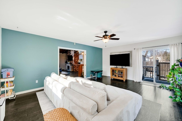 living room with ceiling fan and dark hardwood / wood-style flooring