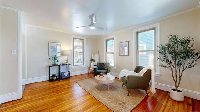 sitting room featuring crown molding, ceiling fan, and light wood-type flooring