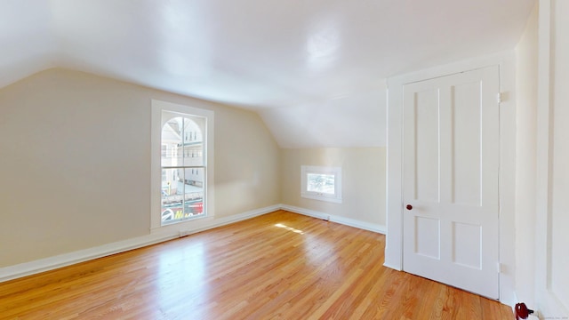 bonus room featuring vaulted ceiling and light hardwood / wood-style floors