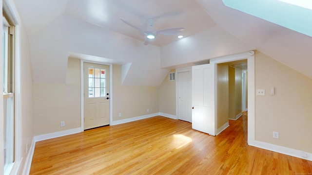 additional living space featuring vaulted ceiling, ceiling fan, and light hardwood / wood-style floors