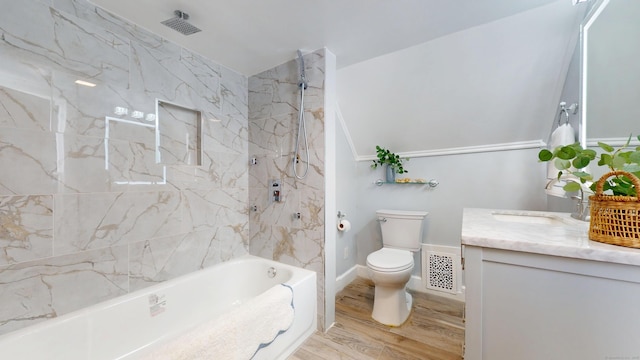 full bathroom featuring vanity, toilet, tiled shower / bath combo, and hardwood / wood-style floors